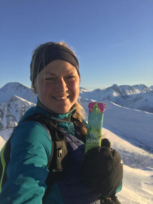 Clean vegan protein bars - Ida is hiking and taking a bar on a mountain