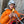 A person wearing a climbing helmet eating a Moonvalley energy bar.