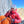 A mountain climber wearing a helmet, eating a Moonvalley energy bar.