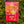 Moonvalley organic Red Apple sports drink powder, photographed in a natural outdoor setting.