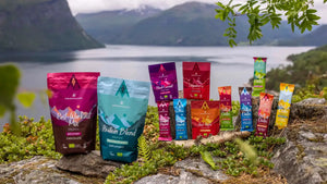 Moonvalley organic range of energy bars, protein bars, sports drinks and recovery products displayed in a scenic outdoor setting.