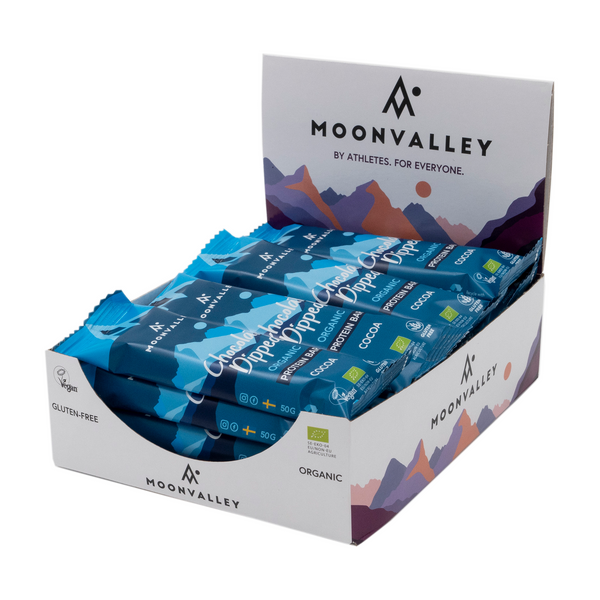 Display box containing 12-pack of Moonvalley Chocolate-Dipped Cocoa protein bars.