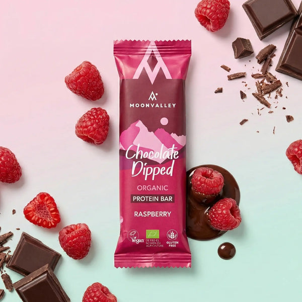 Organic Chocolate-Dipped Raspberry protein bar with fresh raspberries and dark chocolate chunks.