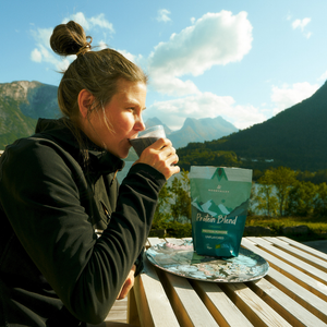 Person enjoying a healthy meal outdoors with a bag of Moonvalley protein powder.