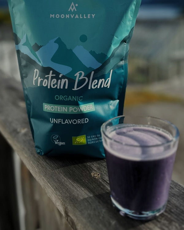 750g bag of Moonvalley Organic Vegan Protein Blend, unflavoured and a glass with protein drink.
