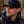 Man wearing a black cap with 'MoonyValley' logo and a backpack in a forest setting