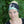 Woman wearing a green Moonvalley Mountain Tube around her head.